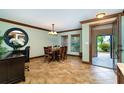 Inviting dining room boasts a wooden table, chandelier, and decorative molding, perfect for gatherings at 26294 Bridgewater Rd, Punta Gorda, FL 33983