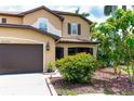 Charming home exterior with brown trim and accents, framed by colorful flowers and lush greenery at 26294 Bridgewater Rd, Punta Gorda, FL 33983