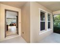 Covered porch with tile floors and neutral paint featuring an open door and screened lanai access at 26294 Bridgewater Rd, Punta Gorda, FL 33983