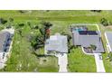 Aerial view showcases the home's location, yard size, and proximity to a neighboring pool at 55 Mark Twain Ln, Rotonda West, FL 33947