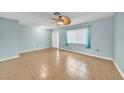 Bright living room featuring tiled floors, neutral walls, and a stylish ceiling fan at 55 Mark Twain Ln, Rotonda West, FL 33947