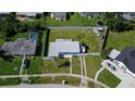 Aerial view of a property with a pool and a fenced yard with a boat at 700 Floral Ln, Port Charlotte, FL 33952