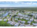 Scenic aerial view of a tranquil community featuring cozy homes surrounding a picturesque lake at 742 Portwine Ct # 17, Englewood, FL 34223