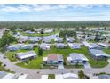 Expansive aerial shot featuring well-kept homes in a peaceful lakeside community with green spaces at 742 Portwine Ct # 17, Englewood, FL 34223