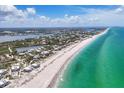 Coastal aerial view of beachfront homes along the shoreline with stunning turquoise waters at 7554 Palm Island S Dr # 1813, Placida, FL 33946