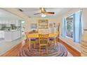 Cozy dining room with a round table, colorful rug, and built-in display cabinet at 7690 Castleberry Ter, Englewood, FL 34224
