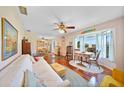 Inviting living room with hardwood floors, a bay window, and cozy seating at 7690 Castleberry Ter, Englewood, FL 34224