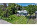 Cozy single-story home with well-kept lawn, shade trees, carport, and white picket fence at 8224 Pinetree Ln, Englewood, FL 34224