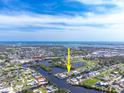 An aerial view showcasing the property's location amidst a network of waterways and its proximity to the bay at 1060 Haste Ln, Englewood, FL 34223