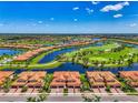 Aerial view showcasing the property's location with a lake and golf course, and neighborhood at 10788 Tarflower Dr # 201, Venice, FL 34293