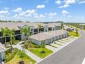 Condo building exterior featuring tile roof, attached garages and mature palm tree landscaping at 12470 Wellen Golf St # 107, Venice, FL 34293