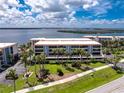 Beautiful condo building featuring tropical landscaping and amazing waterfront views at 1701 Beach Rd # 207, Englewood, FL 34223