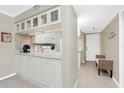 Bright kitchen featuring white cabinets, tile backsplash, and modern appliances at 1701 Beach Rd # 207, Englewood, FL 34223
