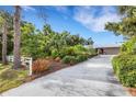 Lovely single-story home surrounded by mature trees and lush landscaping in a serene setting at 1733 Belvidere Rd, Englewood, FL 34223