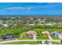 An aerial view showcasing the property with its lush surroundings and proximity to the water at 200 Arlington Dr, Placida, FL 33946