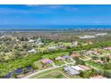 Stunning aerial view of homes near water featuring lush landscaping and beautiful architecture at 200 Arlington Dr, Placida, FL 33946
