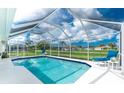 A screened-in pool with poolside furniture, offering a private and relaxing outdoor space for leisure and entertainment at 25 Mariner Ln, Rotonda West, FL 33947