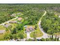 View of a home from above, featuring an inground pool, fenced yard, and lush green landscaping at 2679 Armenia Rd, North Port, FL 34286