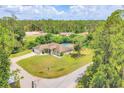 Spacious home featuring an inground pool, fenced yard, and lush green landscaping at 2679 Armenia Rd, North Port, FL 34286