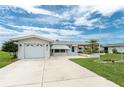 Lovely single-story residence featuring an attached garage, a nicely landscaped front yard, and a cozy covered entry at 39 Caddy Rd, Rotonda West, FL 33947
