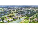 Sprawling neighborhood aerial featuring a golf course, lakes, and well-maintained homes at 39 Pine Valley Ct, Rotonda West, FL 33947