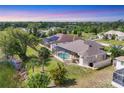 Aerial view of the backyard with a screened pool and lush green space at 39 Pine Valley Ct, Rotonda West, FL 33947