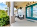 Inviting front porch with elegant columns, a double door entry, and seating at 39 Pine Valley Ct, Rotonda West, FL 33947