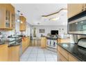 Modern kitchen with granite countertops, stainless steel appliances, wooden cabinets, and an open layout at 4221 Ulster Ave, North Port, FL 34287