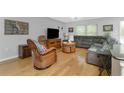 Cozy living room features hardwood floors, comfortable seating, and natural lighting through bright windows at 4221 Ulster Ave, North Port, FL 34287