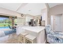 Bright kitchen with white cabinets, stainless steel appliances, and a breakfast bar at 4227 Winona St, Port Charlotte, FL 33948