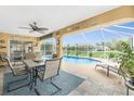 Covered patio with comfortable seating and a view of the pool and backyard at 4227 Winona St, Port Charlotte, FL 33948