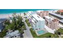 Condo exterior featuring a swimming pool, balconies, and well-maintained landscaping at 50 Meredith Dr # 9, Englewood, FL 34223