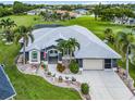A beautiful single-story home showing the roof, front yard, landscaping and the surrounding neighborhood at 7130 Scarlet Sage Ct, Punta Gorda, FL 33955