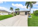 Beautiful single-story home with an attached two-car garage, landscaping, and concrete driveway at 7130 Scarlet Sage Ct, Punta Gorda, FL 33955
