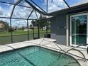 Screened-in pool with clear blue water, brick paver deck, and view of the surrounding neighborhood at 7130 Scarlet Sage Ct, Punta Gorda, FL 33955