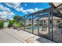 The screened-in pool area features comfortable seating and a paved patio, perfect for relaxation and entertaining at 7218 Darlington St, Englewood, FL 34224