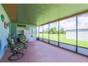 Relaxing screened patio with comfortable seating, offering a serene view of the backyard and surrounding greenery at 7437 Bass St, Englewood, FL 34224