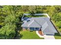 An aerial view shows the roof and large fenced yard of this single Gathering home at 7933 Minardi St, North Port, FL 34291