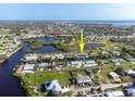 Aerial view of a waterfront community with canals and lush landscaping at 1030 Haste Ln, Englewood, FL 34223