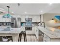 Renovated kitchen with custom backsplash, updated appliances and breakfast bar at 1401 S Mccall Rd # 205, Englewood, FL 34223