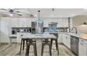 A kitchen island offers seating, prep space and stainless appliances at 1401 S Mccall Rd # 205, Englewood, FL 34223