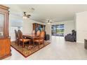 Spacious dining room with hardwood table and leather chairs, with easy access to the pool at 14756 Ponce De Leon Trl, Port Charlotte, FL 33981