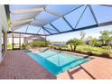 Screened pool with attached jacuzzi and beautiful backyard and lake views at 14756 Ponce De Leon Trl, Port Charlotte, FL 33981