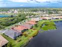 Ariel view of a well maintained home with lakeside access and beautiful landscaping at 1530 Hyssop Loop, North Port, FL 34289