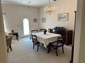 Bright dining room featuring a chandelier, furniture and a white door at 18122 Windswept Ave, Port Charlotte, FL 33948