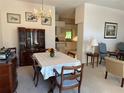 Formal dining room with a china cabinet and an open view to the bright kitchen at 18122 Windswept Ave, Port Charlotte, FL 33948