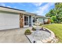 Close-up of the entrance featuring a charming fountain, stone accents, and screened entry at 2541 Northway Dr, Venice, FL 34292