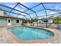 A screened-in pool with paver deck offering a private outdoor retreat at 2541 Northway Dr, Venice, FL 34292