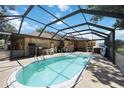 Inviting screened-in pool with ample deck space for outdoor relaxation and entertaining at 27581 Tierra Del Fuego Cir, Punta Gorda, FL 33983