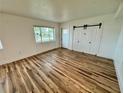 Cozy bedroom with hardwood floors, ample natural light, and a convenient sliding door closet for storage at 300 Dalton Blvd Blvd, Port Charlotte, FL 33952